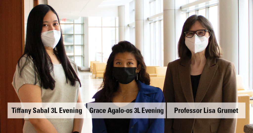 Two female law students and a female law professor in masks stand in a well-lit hallway at New York Law School. R to L: Tiffany Sabal 3L Evening, Grace Agalo-os 3L Evening, and Professor Lisa Grumet