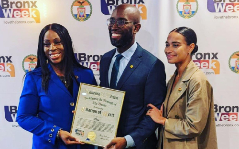 Eric Henry accepts a citation of merit from Bronx Borough President Vanessa Gibson and Deputy Borough President Janet Peguero .