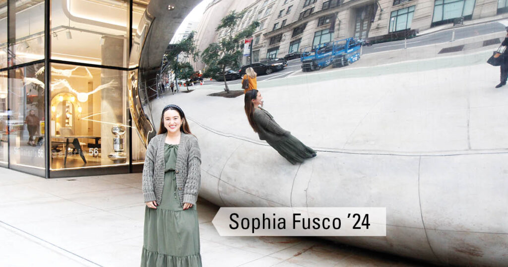 Sophia Fusco standing in front of The Bean